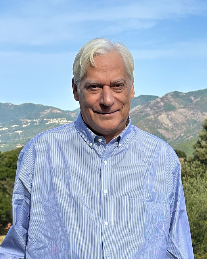 René Pérès, en chemise claire, devant les montagnes de l'intérieur corse.